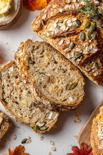 Delicious crusty no-knead seeded oat bread perfect for autumn gatherings, filled with wholesome seeds for added flavor and nutrition.