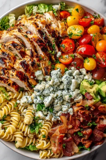 Balsamic Chicken Cobb Salad with Pasta served in a bowl, featuring grilled chicken, fresh veggies, and pasta, perfect for holiday meals.