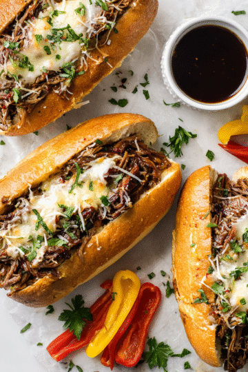 Delicious Instant Pot Italian Beef Sandwiches served on hoagie rolls with melted cheese, perfect for gatherings. Quick, hearty comfort food.
