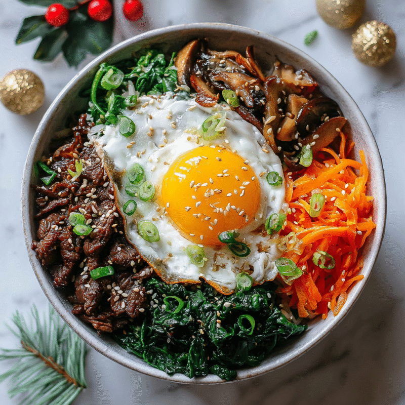 Delicious quick Korean Bibimbap with marinated beef, colorful vegetables, and a fried egg for a cozy and satisfying meal.