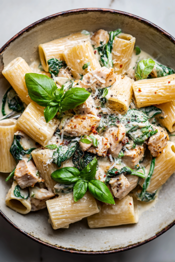 A creamy chicken rigatoni dish featuring pasta, chicken, spinach, and creamy sauce made with Parmesan cheese, perfect for autumn dinners.