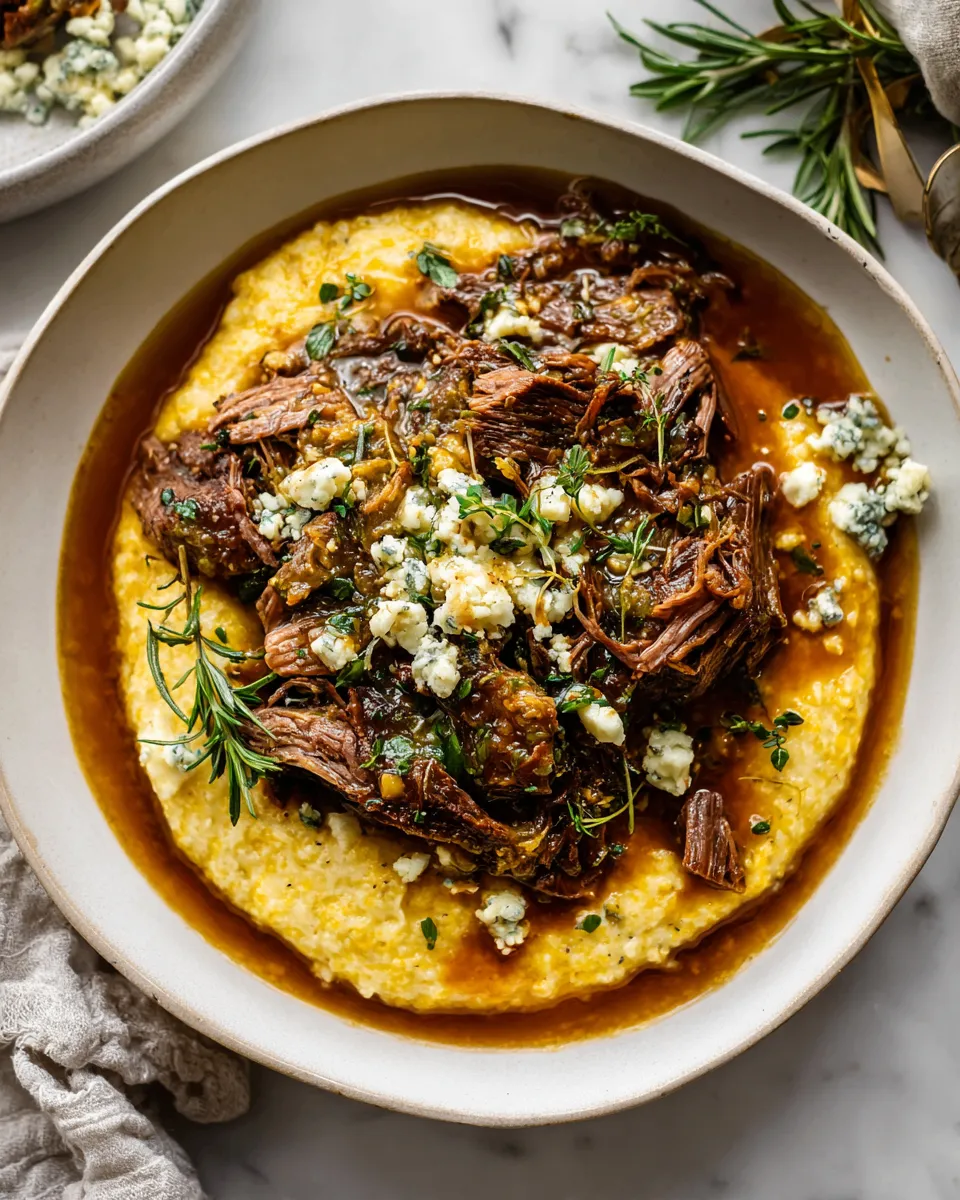 Italian pot roast with creamy Gorgonzola polenta served in a rustic dish, perfect for holiday gatherings. Delicious and comforting meal idea.