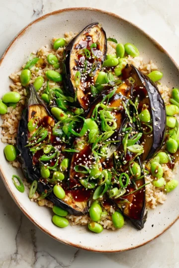Delicious Miso Aubergine with Edamame and Brown Rice Miso Aubergine with Edamame Beans and Brown Rice, a hearty vegan dish ideal for fall gatherings.
