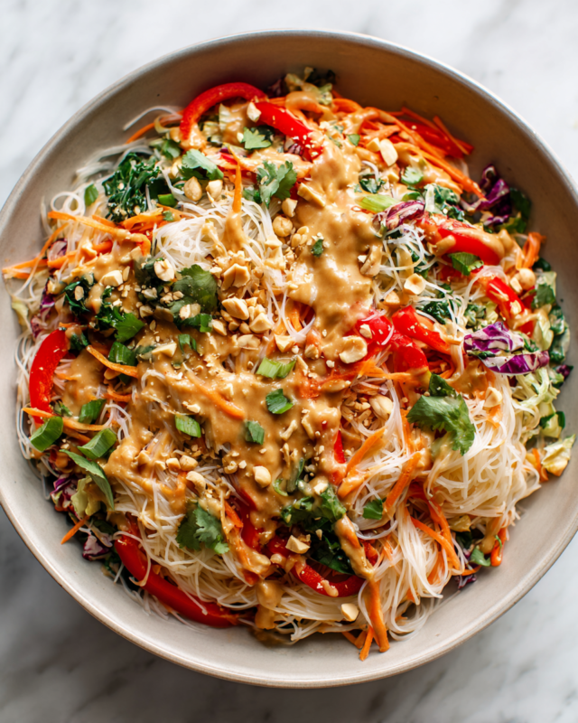 Thai Noodle Salad with Peanut Sauce topped with fresh ingredients, vibrant and colorful dish perfect for gatherings and holiday tables.