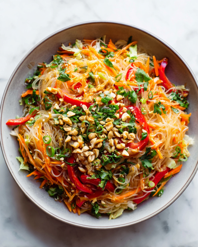 A Vibrant Thai Noodle Salad with Peanut Sauce Thai Noodle Salad with Peanut Sauce topped with fresh ingredients, vibrant and colorful dish perfect for gatherings and holiday tables.