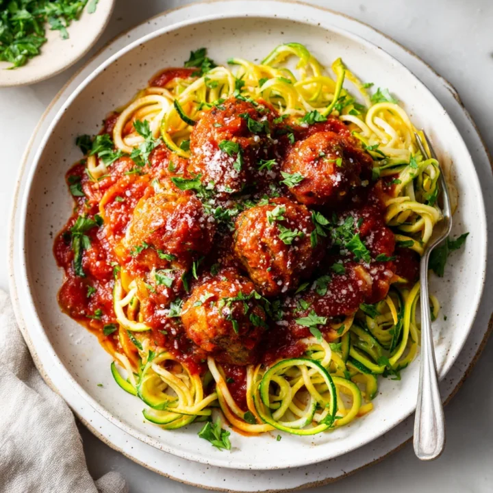 Comforting Turkey Meatball Marinara with Courgettie Turkey Meatball Marinara with Courgettie and Wholewheat Spaghetti, a healthy and hearty meal ideal for autumn gatherings.