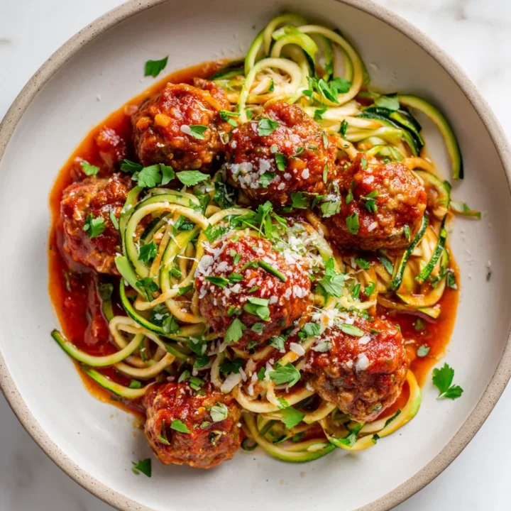 Comforting Turkey Meatball Marinara with Courgettie Turkey Meatball Marinara with Courgettie and Wholewheat Spaghetti, a healthy and hearty meal ideal for autumn gatherings.