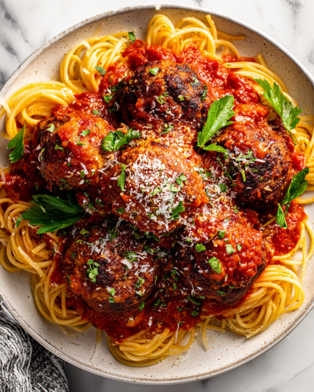 Delicious meatballs in a rich tomato sauce served with pasta. Perfect comfort food for autumn gatherings. Easy to make ahead and freeze.