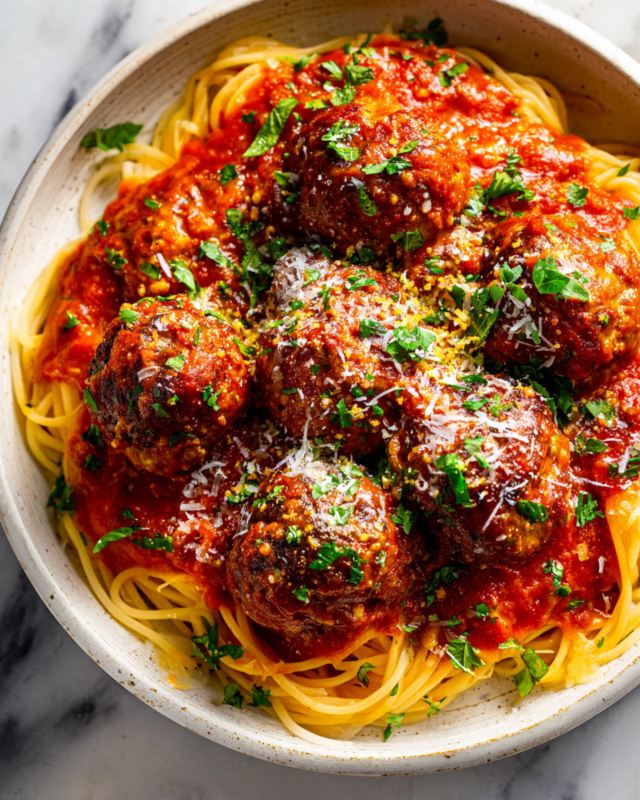 Comforting Meatballs in Tomato Sauce Delicious meatballs in a rich tomato sauce served with pasta. Perfect comfort food for autumn gatherings. Easy to make ahead and freeze.